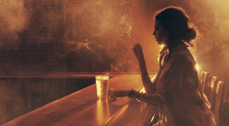 woman smoking at a bar