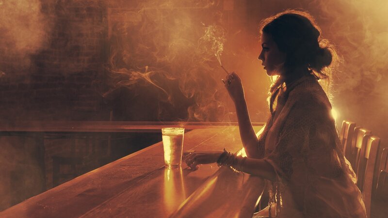 woman smoking at a bar