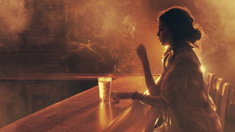 woman smoking at a bar