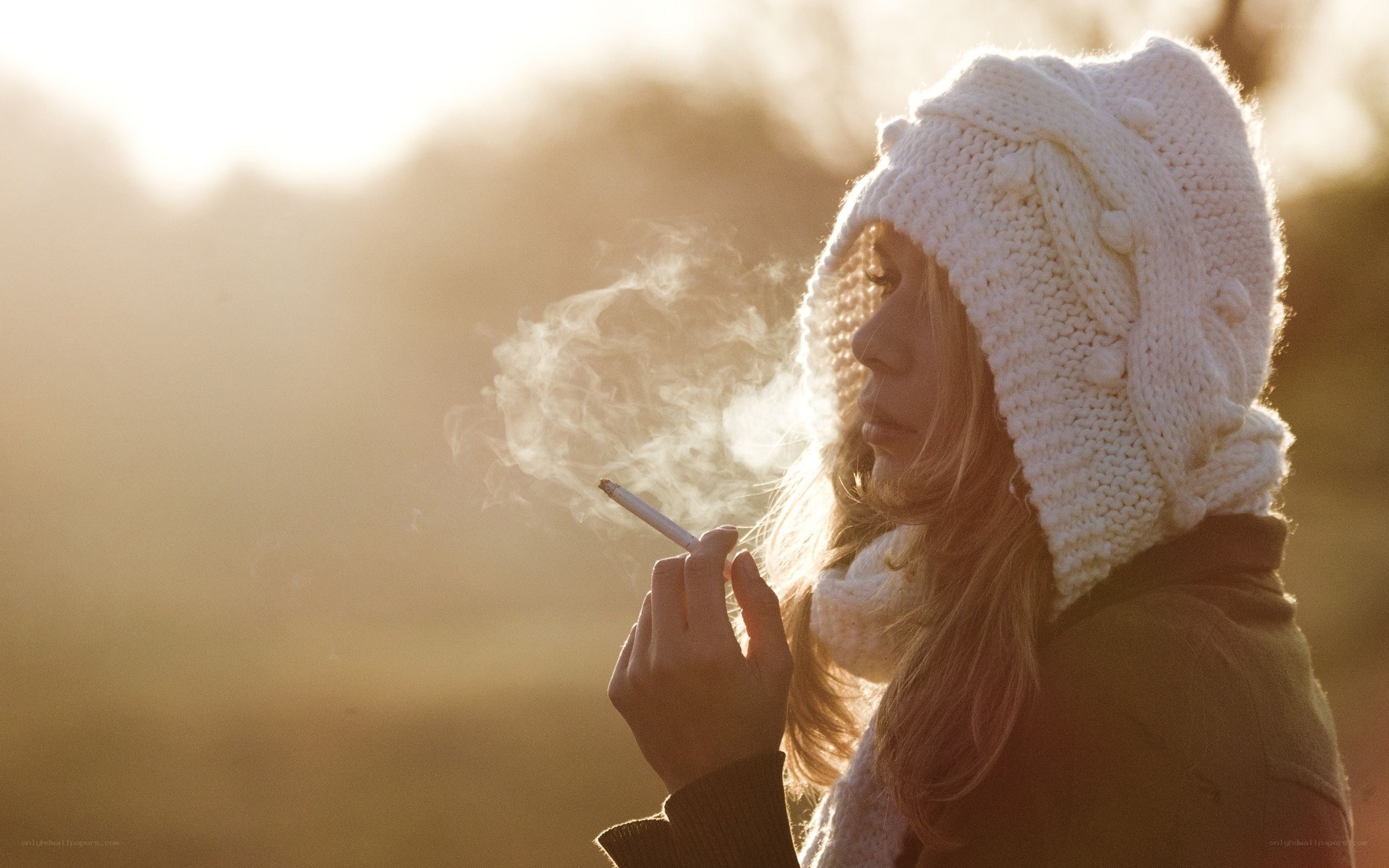 woman smoking at sunset