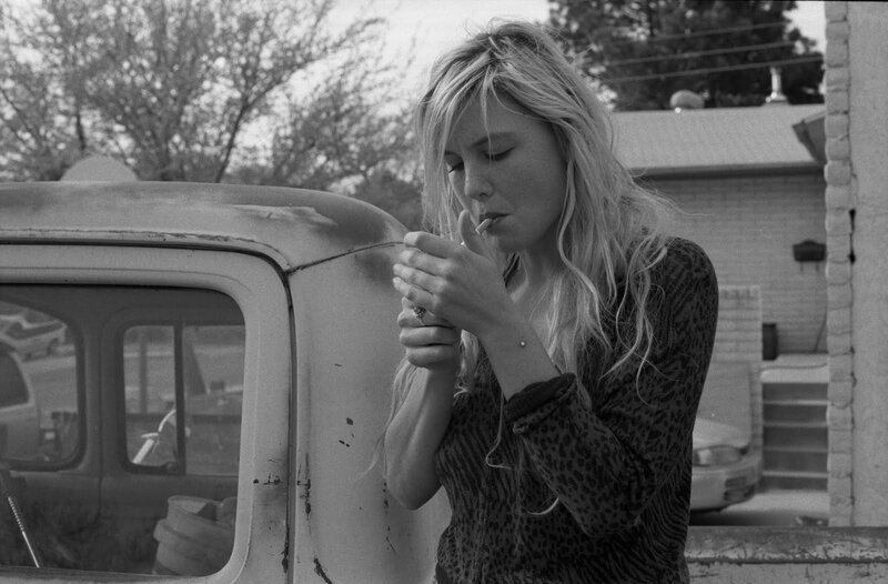 woman smoking by a truck