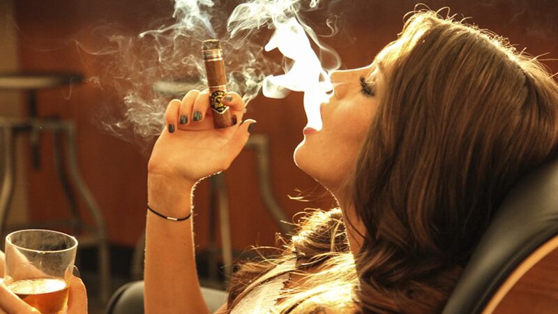 woman smoking cigar in lounge