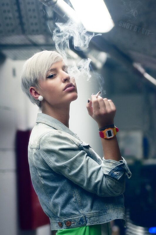 woman smoking in denim jacket