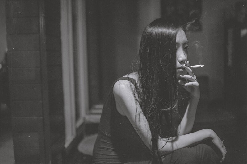 woman smoking in dim light