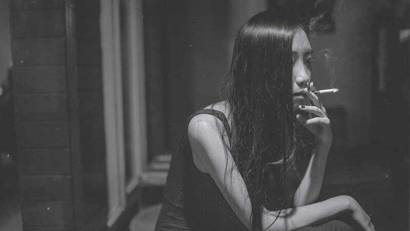 woman smoking in dim light