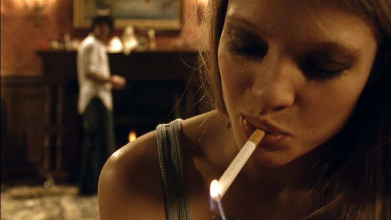 woman smoking in dim room