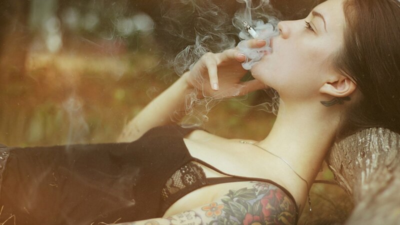 woman smoking in forest