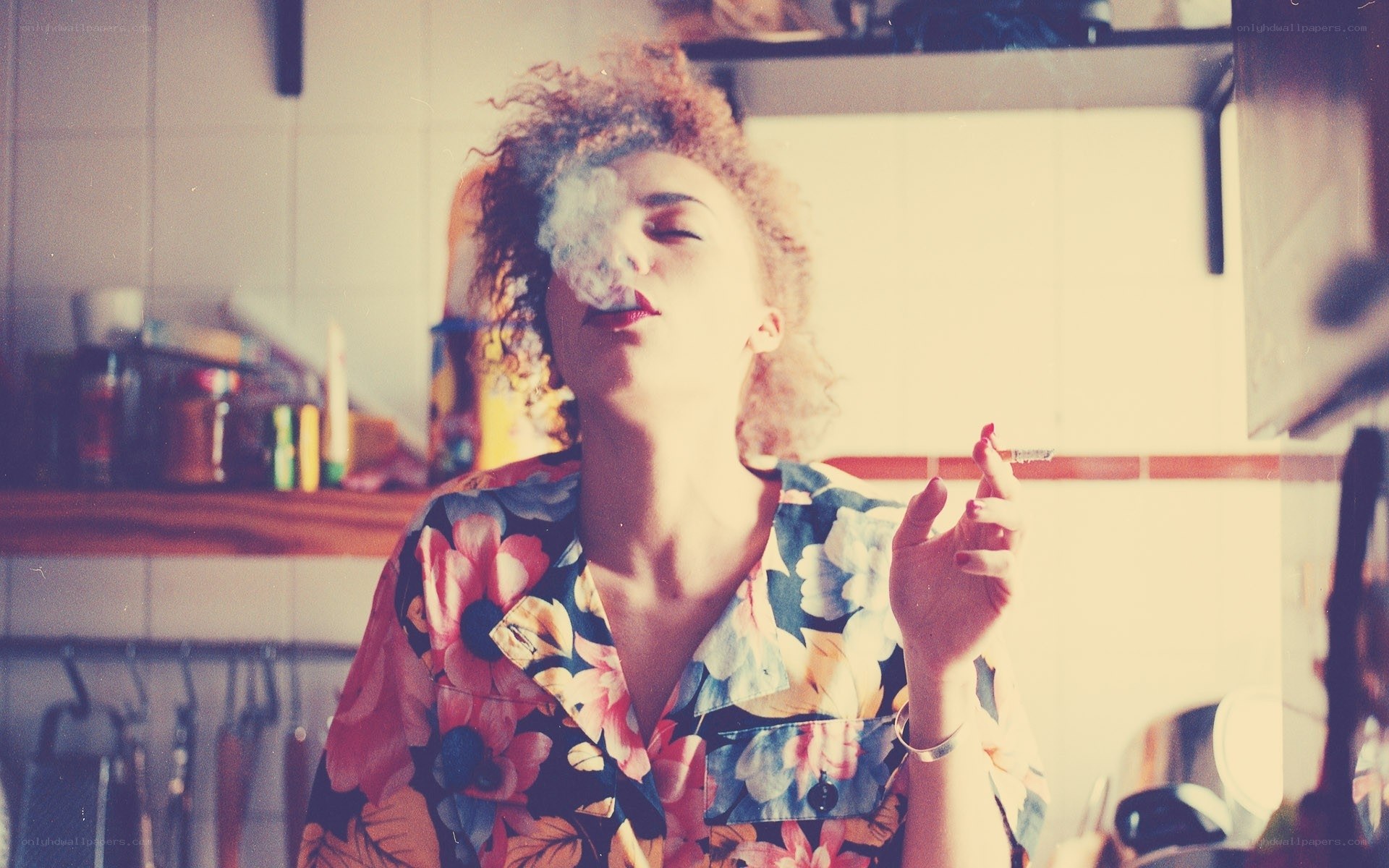 woman smoking in kitchen