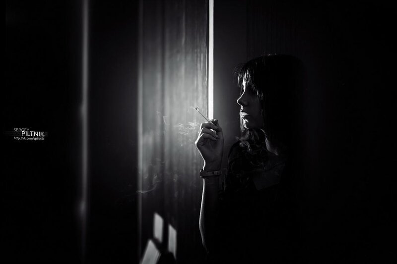 woman smoking in silhouette
