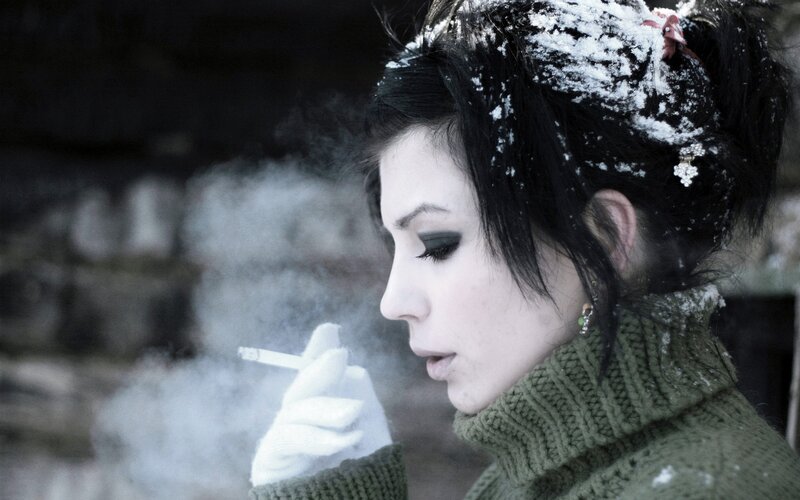 woman smoking in snow