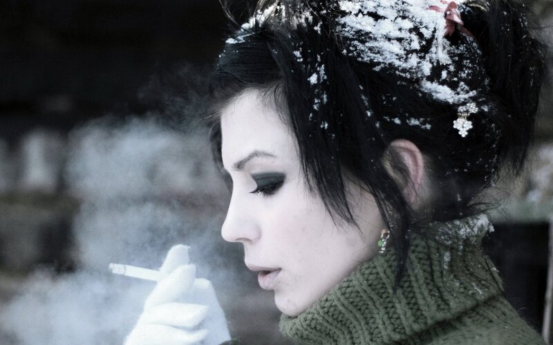 woman smoking in snow