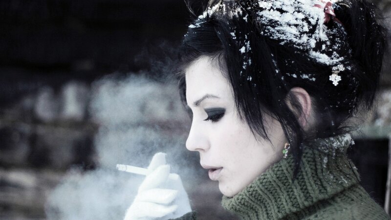 woman smoking in snow