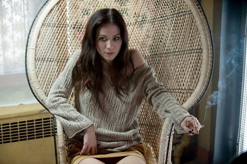 woman smoking in wicker chair