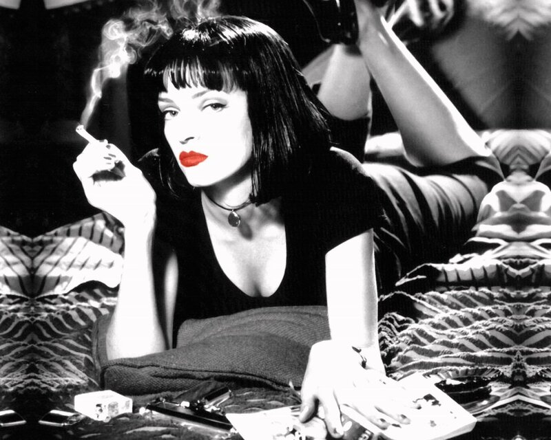 woman smoking on a bed