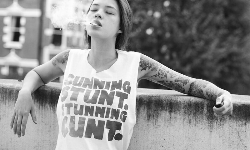 woman smoking on a bridge