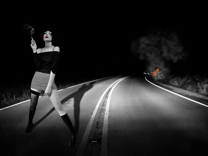 woman smoking on a dark road