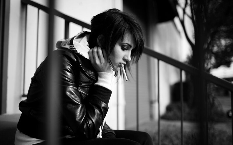 woman smoking on stairs