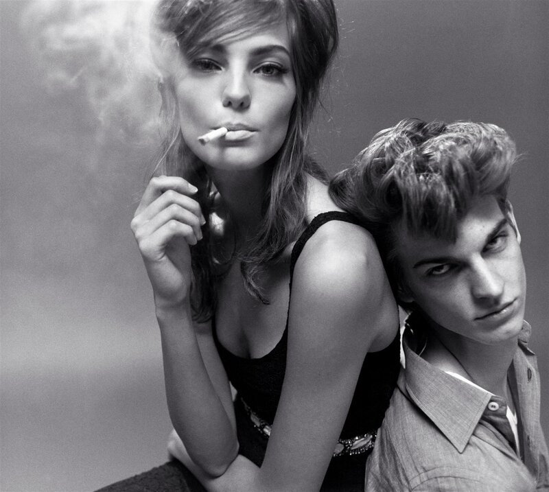 woman smoking with man behind