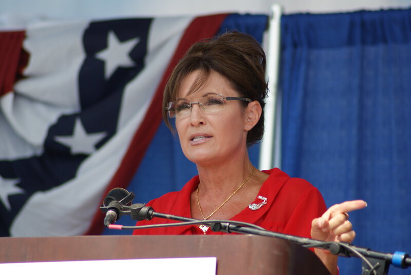 Woman Speaking at Podium — Red