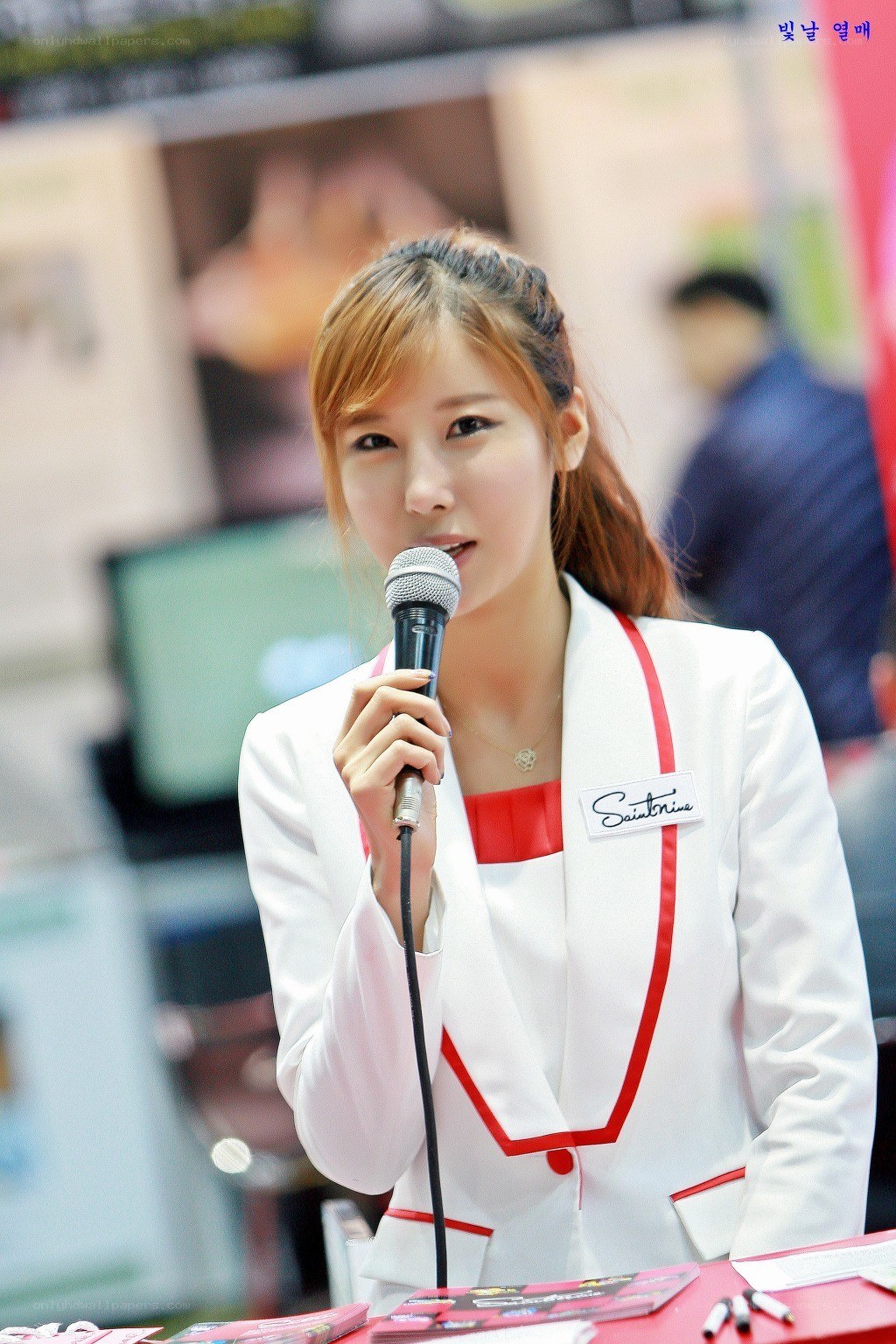 woman speaking into microphone
