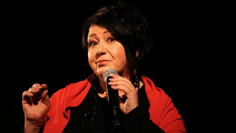 Woman Speaking into Microphone — Black, Dramatic