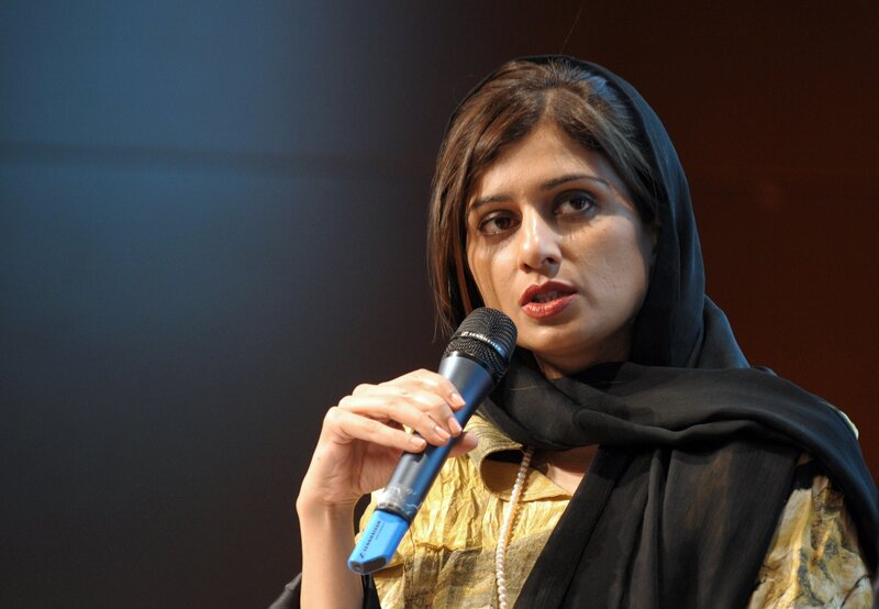Woman Speaking into Microphone — Black