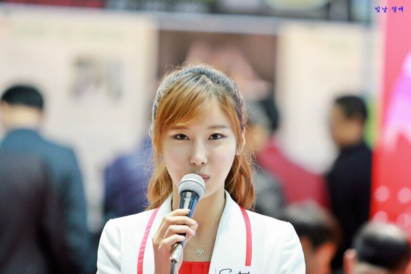 Woman Speaking into Microphone — White, Neutral