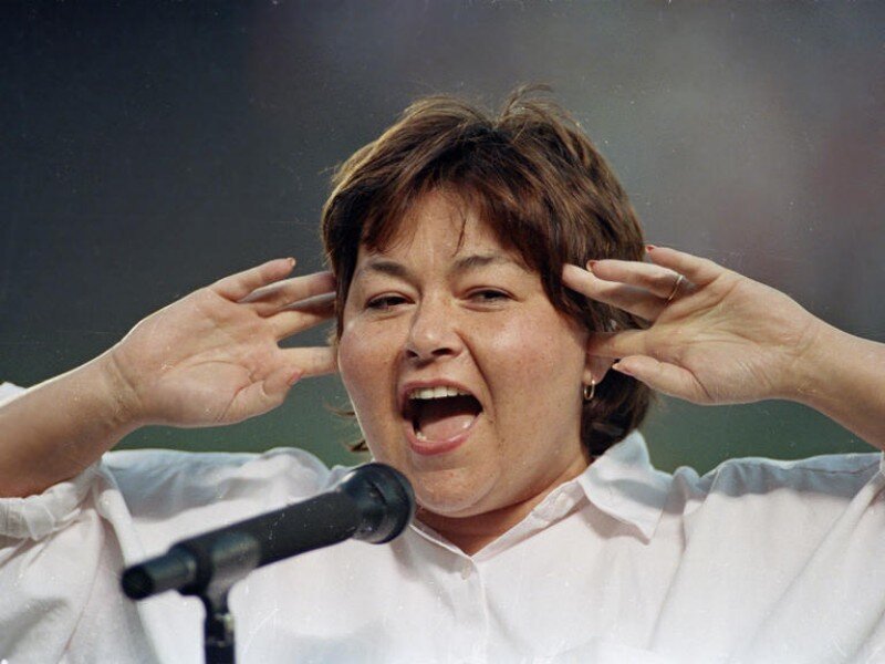 Woman Speaking into Microphone — White