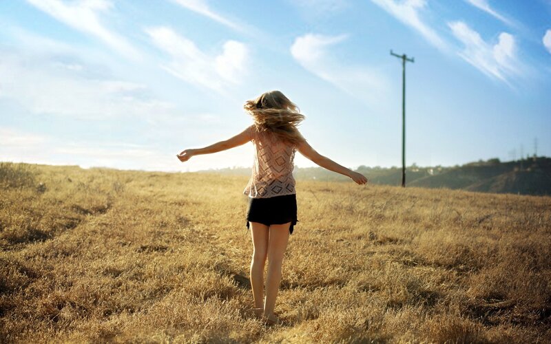 woman spinning in a field