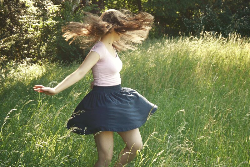 Woman spinning in a field