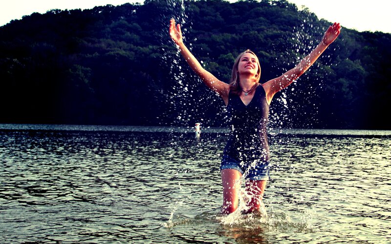 woman splashing in lake