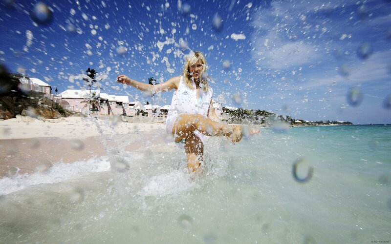 Woman splashing in ocean water