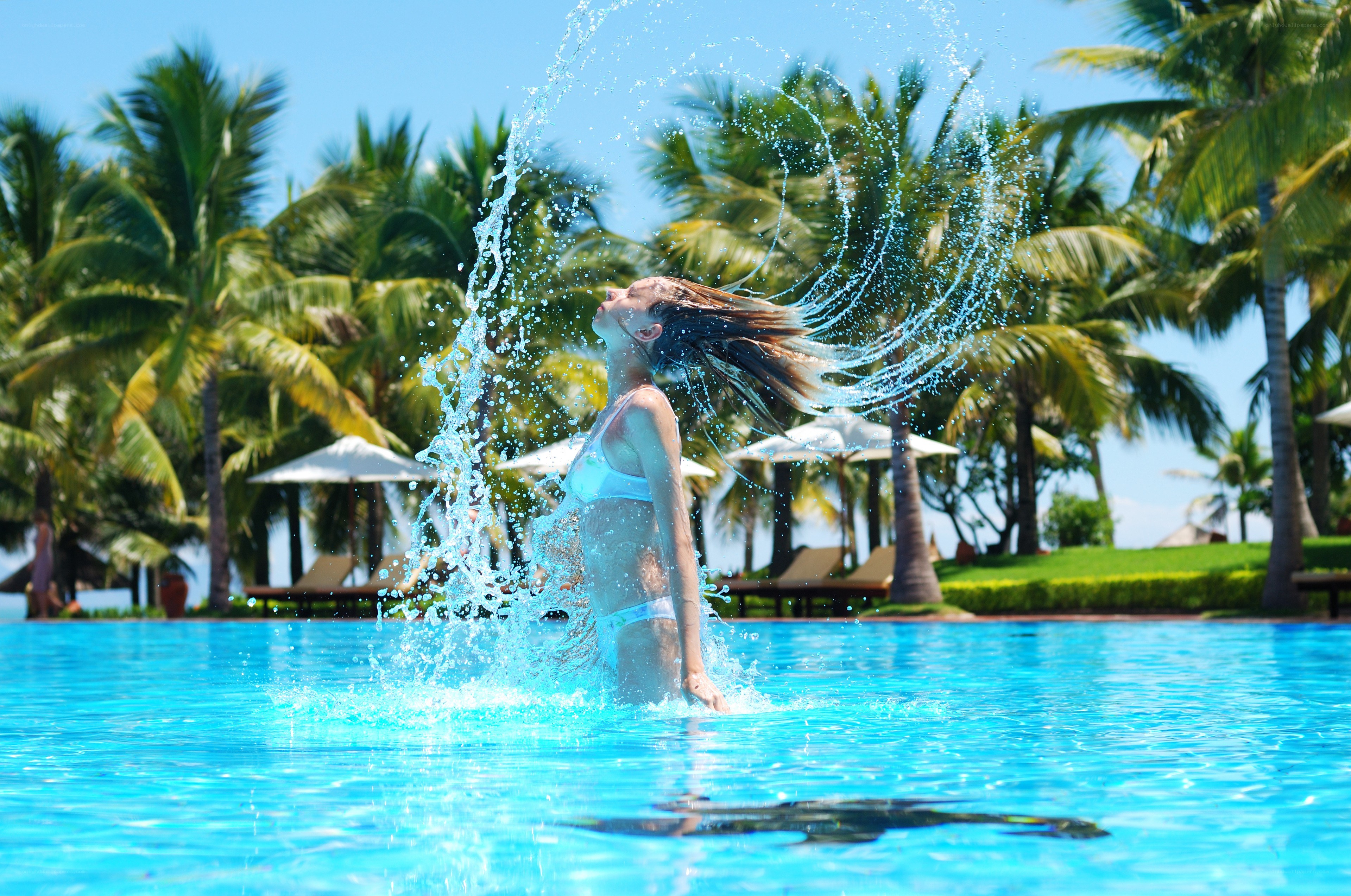 woman splashing in pool