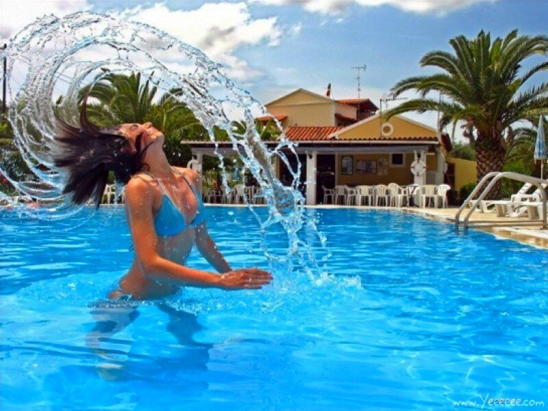 woman splashing in pool