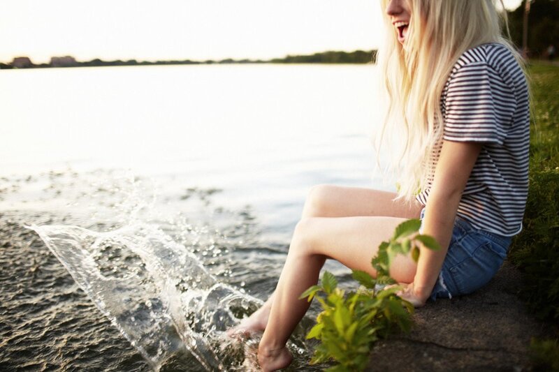 woman splashing water at lake