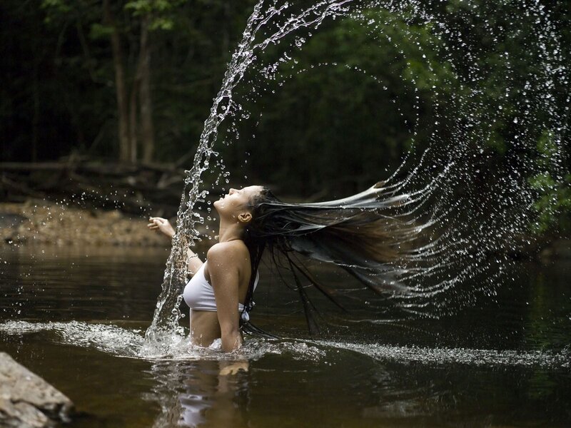 Woman splashing water in river