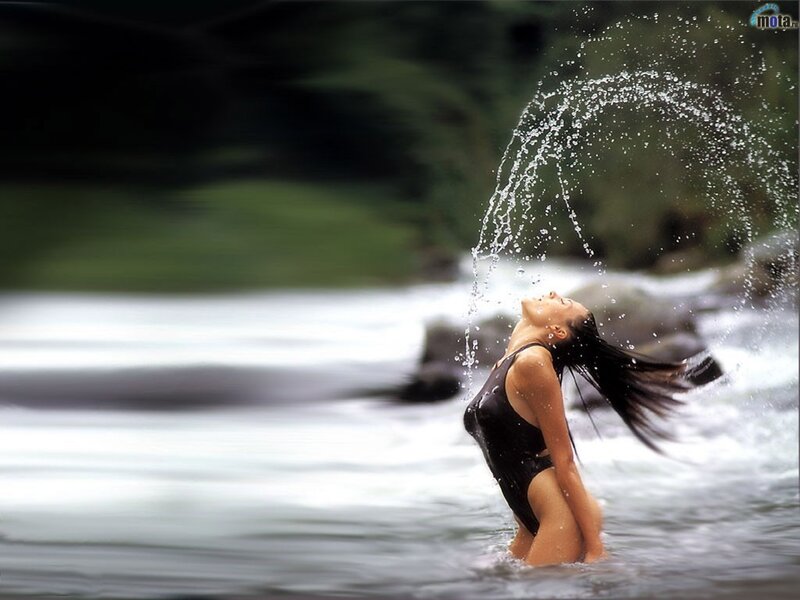 woman splashing water in river