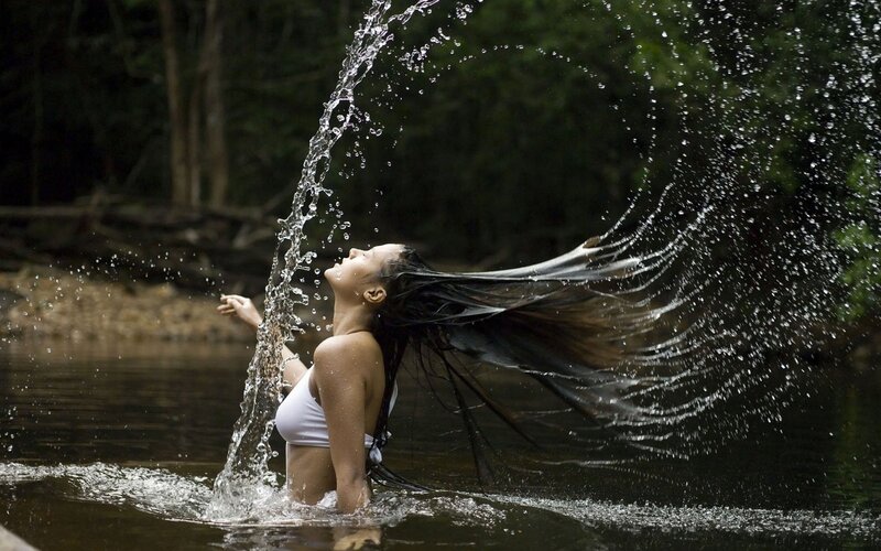 woman splashing water in river