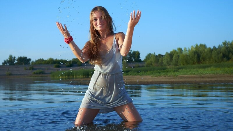 woman splashing water in river