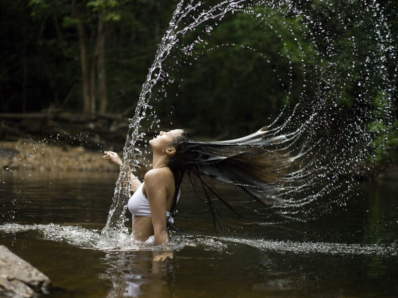 Woman splashing water in river