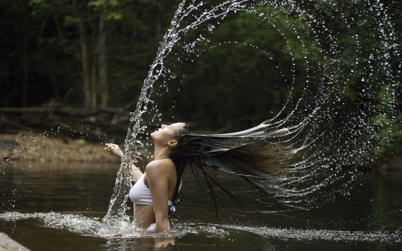 woman splashing water in river