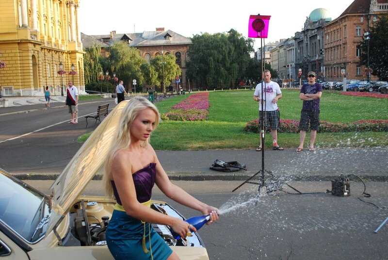 Woman spraying champagne from car