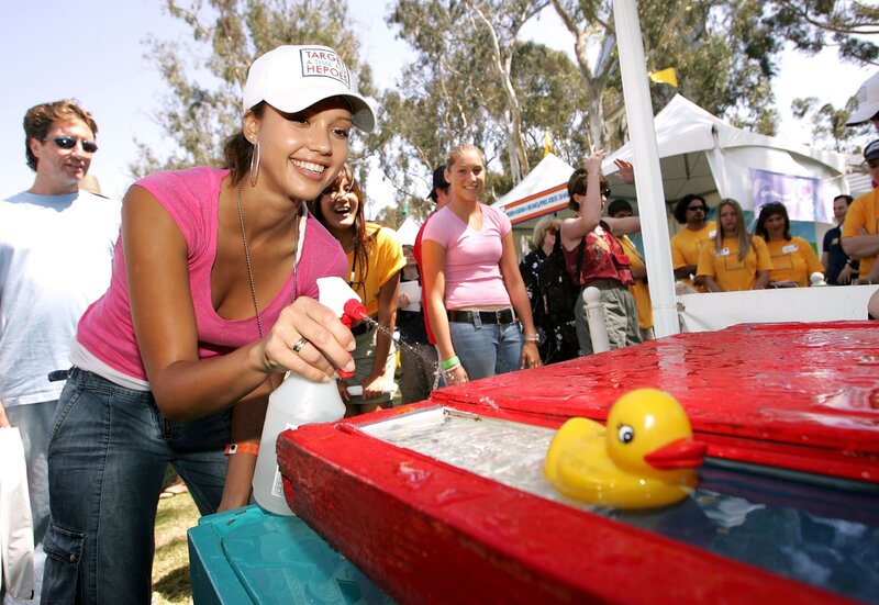 Woman spraying water at duck race