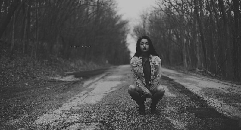 woman squatting on road