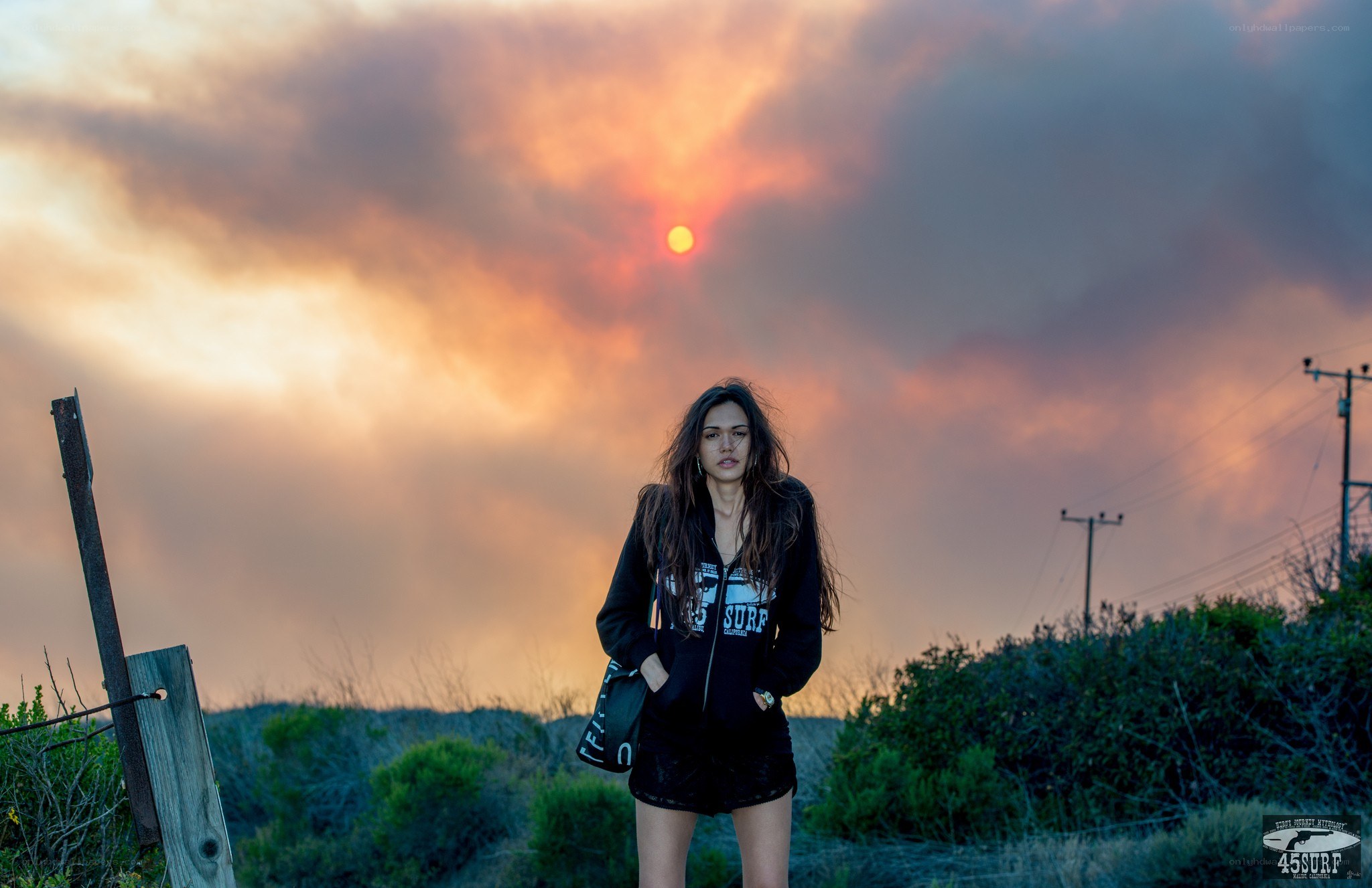 woman standing at sunset