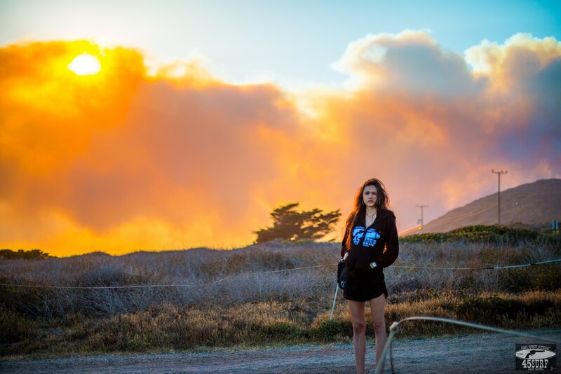 Woman standing at sunset