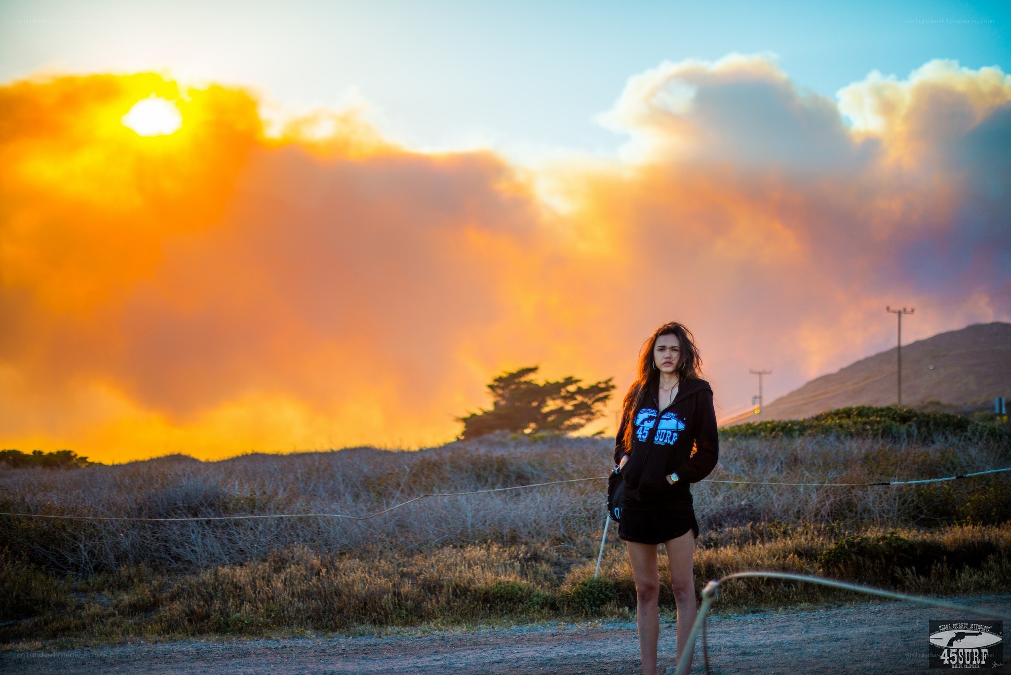 Woman standing at sunset