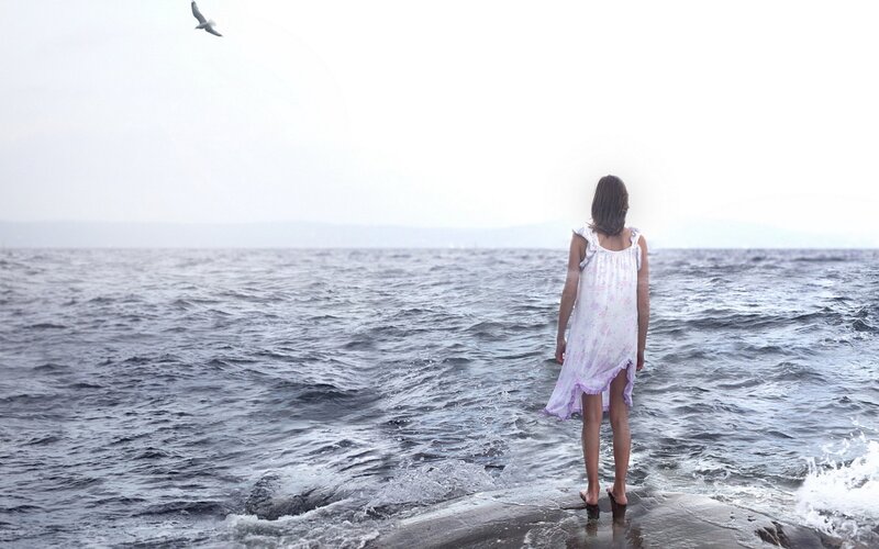 woman standing at the sea