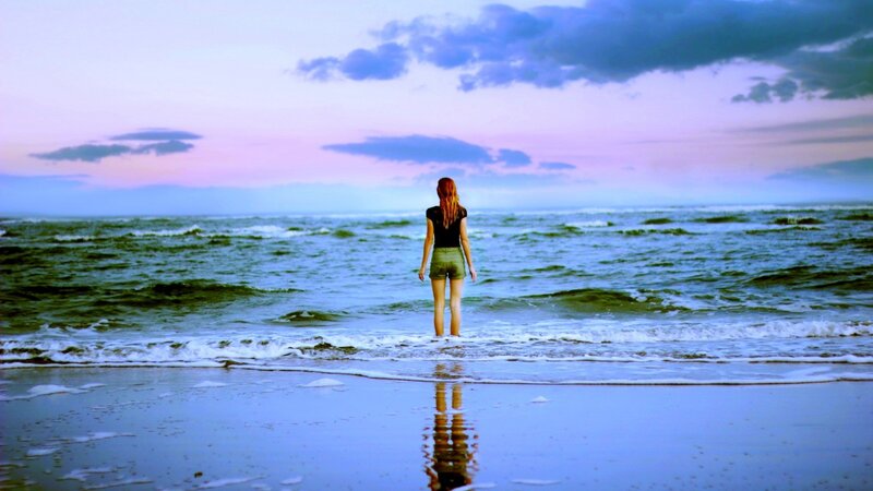 woman standing at the shoreline