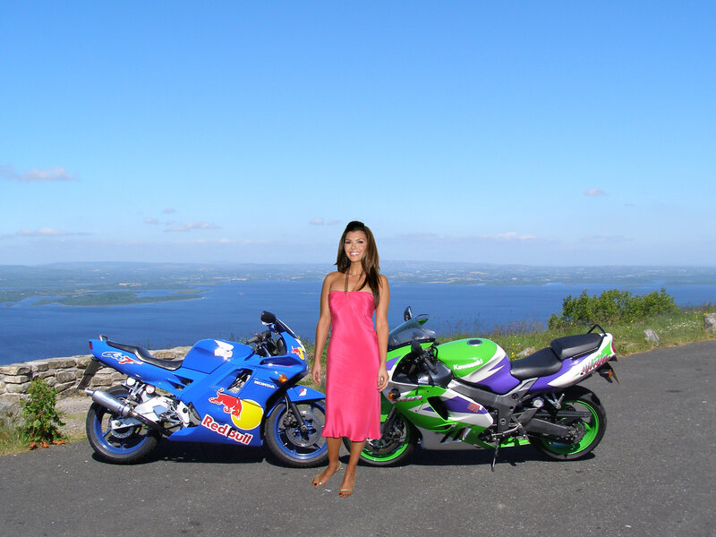 Woman Standing Between Motorcycles